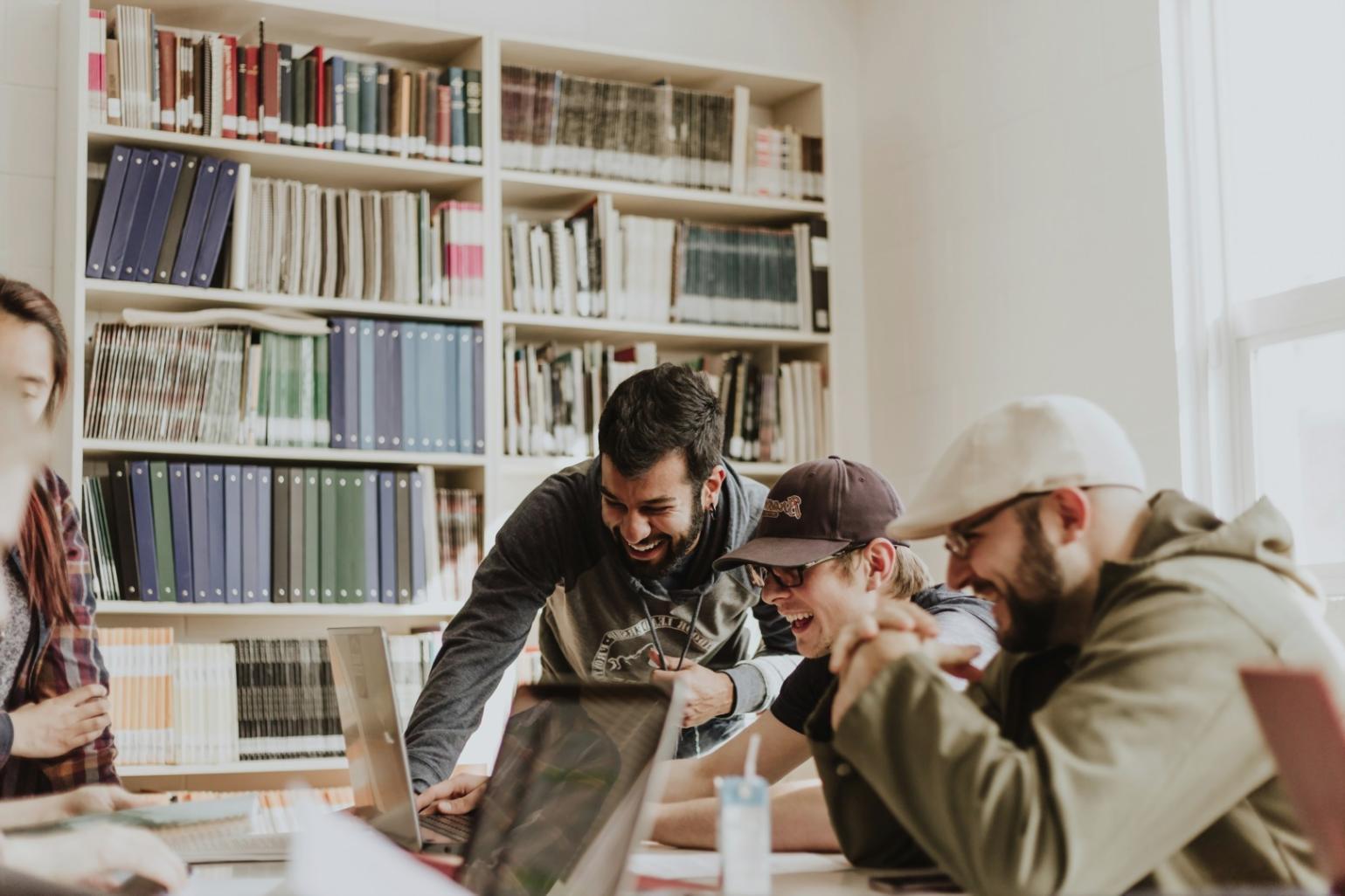 Developer working on game development project with multiple monitors showing code and game interface